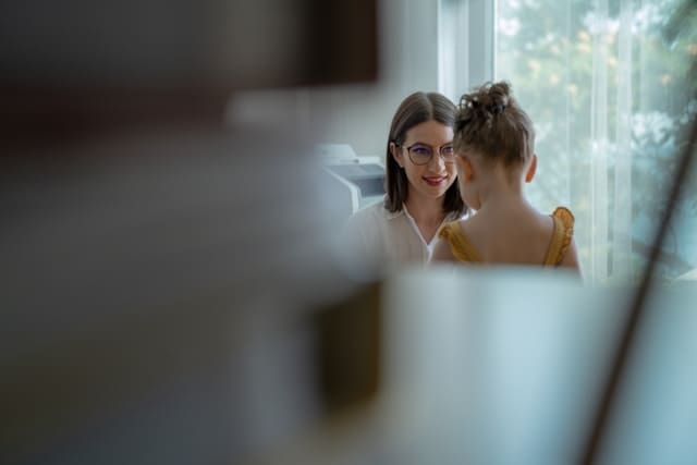 Picture of an adult talking to a kid